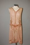 Lot 203 - A pink beaded muslin gown, circa 1927-28, with...