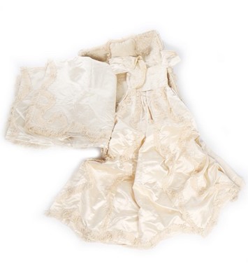 Lot 27 - A quilted ivory silk layette basket and...