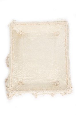 Lot 27 - A quilted ivory silk layette basket and...