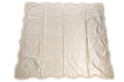Lot 27 - A quilted ivory silk layette basket and...