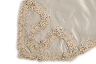 Lot 27 - A quilted ivory silk layette basket and...