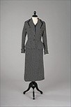 Lot 238 - A Paquin navy and white polka dot tailored...