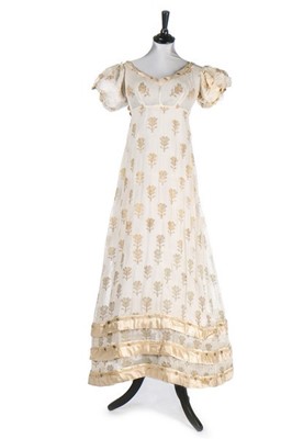 Lot 37 - A brocaded muslin evening dress, circa 1820,...