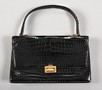 Lot 88 - An Hermès black crocodile handbag, circa 1960,...