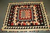 Lot 210 - A patchwork coverlet made from woollen uniform...