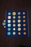 Lot 47 - A display board and loose of enamelled buttons,...
