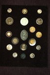 Lot 64 - A display board and loose of buttons relating...