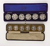 Lot 48 - Four cased sets of silver buttons, comprising:...