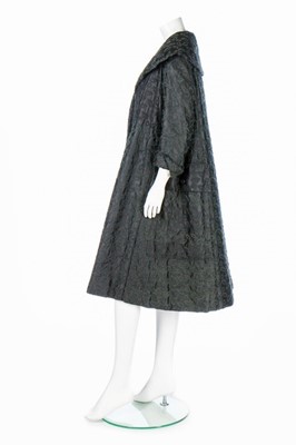 Lot 85 - A Jacques Fath embroidered black satin tent coat, 1954
