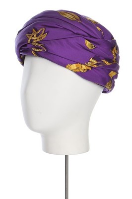 Lot 22 - An Hermès printed purple silk turban, probably...