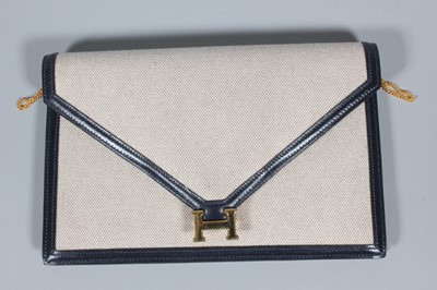 Lot 116 - An Hermès canvas and navy leather envelope...