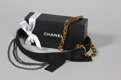 Lot 147 - Two Chanel belts, one of black felt with bow...