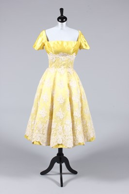 Lot 295 - A lemon satin and ivory lace evening gown,...