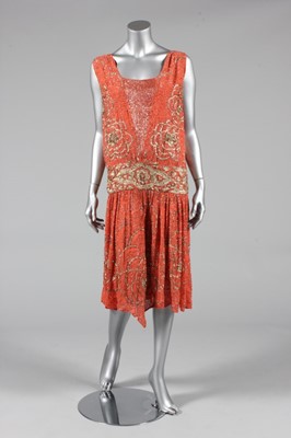 Lot 296 - A beaded coral crepe flapper dress, circa 1928,...