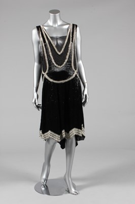 Lot 303 - A black beaded flapper dress, circa 1928, the...