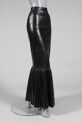 Lot 327 - An Azzedine Alaia black leather skirt, 1999,...