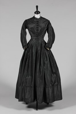 Lot 450 - A black taffeta mourning gown, mid 1860s