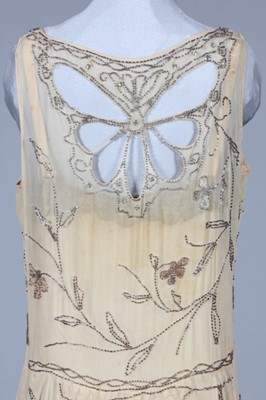 Lot 301 - An beaded ivory chiffon flapper dress with...