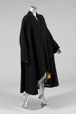 Lot 319 - A Paquin couture black moss crepe swing-coat,...