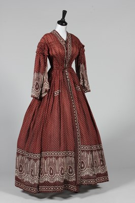 Lot 324 - A printed cotton day dress, circa 1850, with...