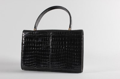 Lot 14 - A black crocodile handbag, early 1960s,...