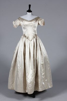 Lot 50 - An ivory satin bridal gown, circa 1845, with...