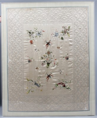 Lot 282 - A quilted and embroidered ivory silk cradle...