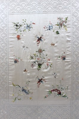 Lot 282 - A quilted and embroidered ivory silk cradle...
