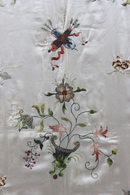 Lot 282 - A quilted and embroidered ivory silk cradle...