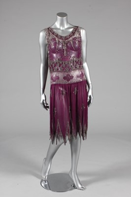 Lot 63 - A beaded magenta chiffon flapper dress, circa...