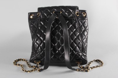 Lot 4 - A Chanel quilted black leather duffle bag,...