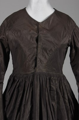 Lot 89 - A smoke grey-brown silk taffeta dress, early...