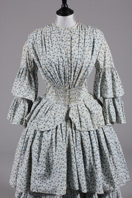 Lot 63 - A printed cotton day dress, circa 1855, with...