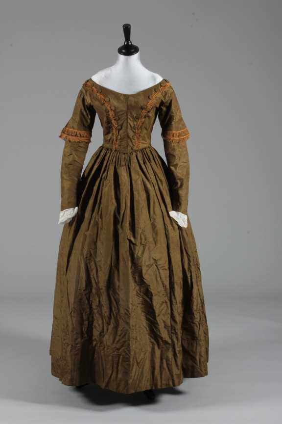 Lot 77 - A bronze silk taffeta day dress, circa 1840,...