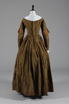 Lot 77 - A bronze silk taffeta day dress, circa 1840,...