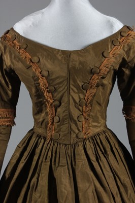 Lot 77 - A bronze silk taffeta day dress, circa 1840,...