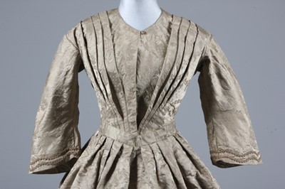 Lot 65 - A mushroom silk damask dress, mid 19th century...