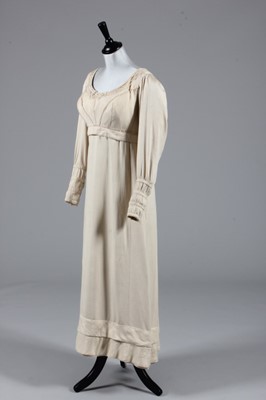Lot 76 - An oyster-pink figured silk gown, circa 1815,...