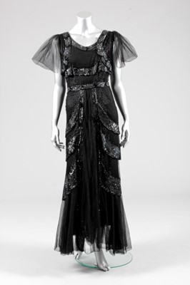 Lot 105 - A black sequined tulle evening gown, early...