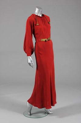 Lot 100 - A burnt orange crpe evening gown, possibly a...