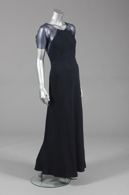 Lot 104 - A Jean Patou navy cloqué silk evening gown,...
