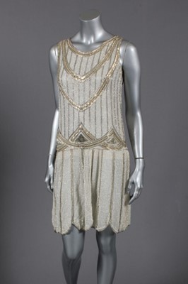 Lot 115 - A stylish beaded flapper dress, French, 1927,...