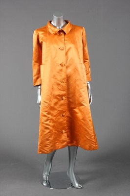 Lot 136 - A Balenciaga deep tangerine satin evening coat,...