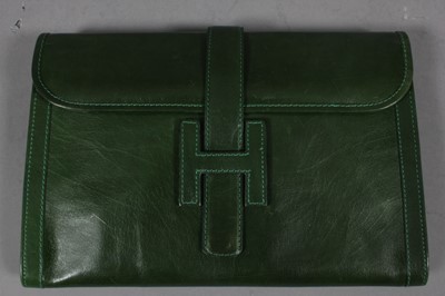 Lot 192 - An Hermès green leather clutch bag, 1970s,...