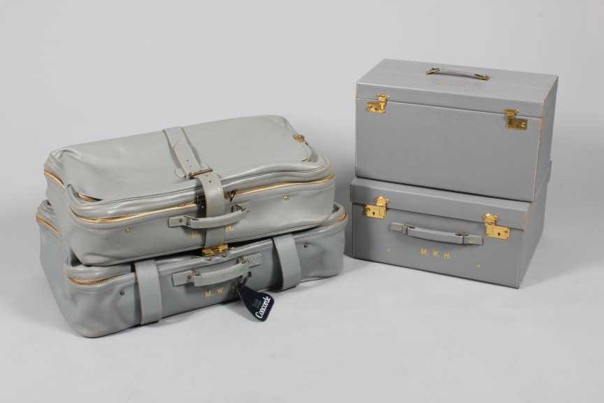 Lot 26 - A suite of powder blue leather luggage,...