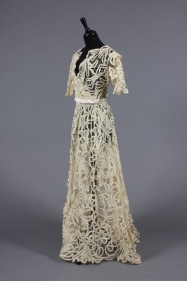 Lot 275 - An Edwardian style tapelace gown, of cream...