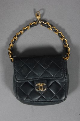 Lot 322 - A Chanel navy quilted leather miniature...