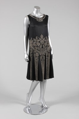 Lot 130 - A black satin flapper dress, circa 1927,...