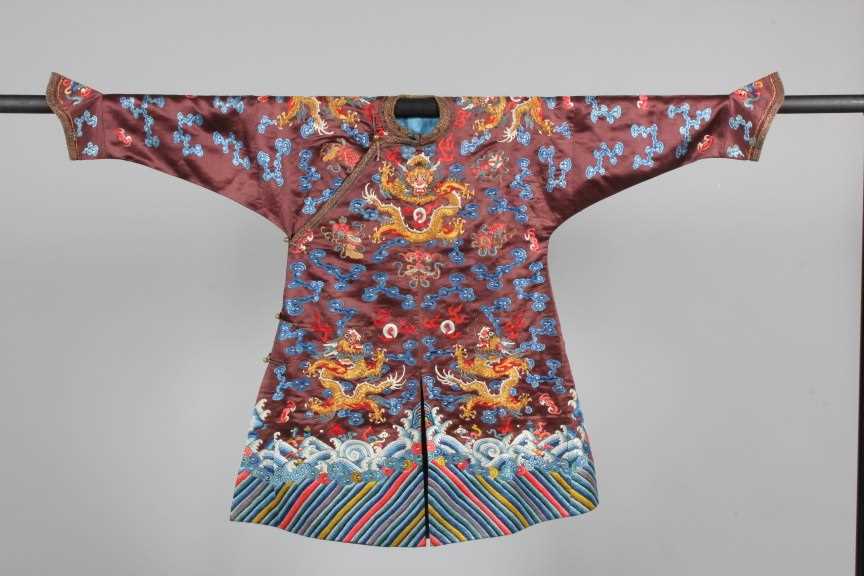 Lot 182 - A boy's chestnut satin embroidered dragon robe,...