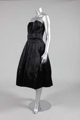 Lot 199 - A Jean Dessès black satin cocktail dress, late...